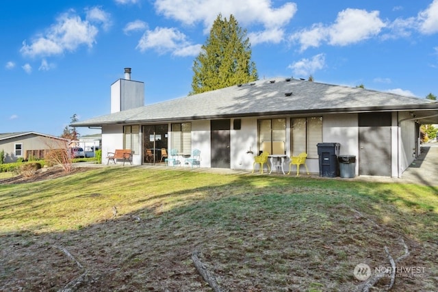 rear view of house with a yard