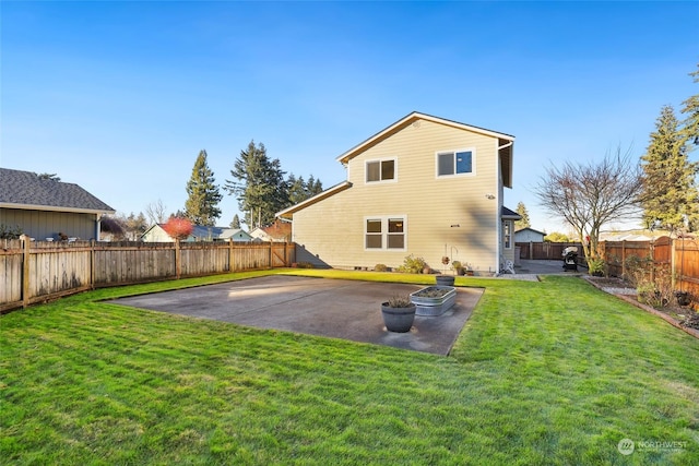 back of house featuring a patio area and a lawn