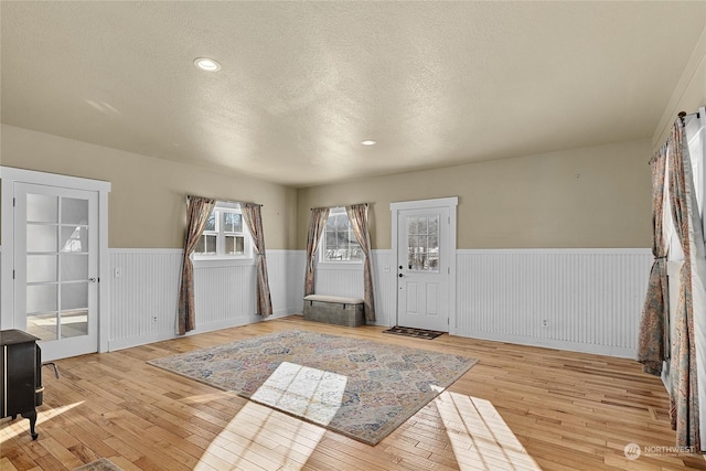 foyer with light hardwood / wood-style floors and a textured ceiling