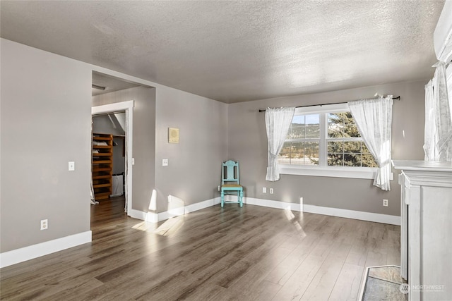 empty room featuring dark hardwood / wood-style floors and a textured ceiling