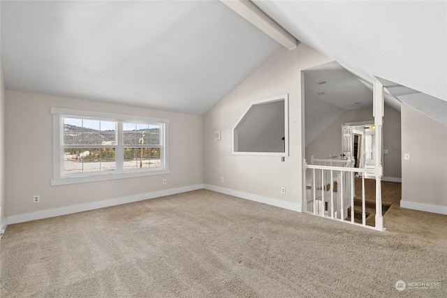 additional living space with vaulted ceiling with beams and carpet flooring