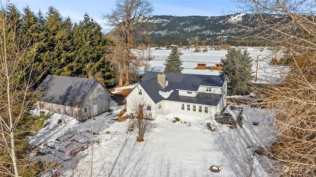 snowy aerial view featuring a mountain view