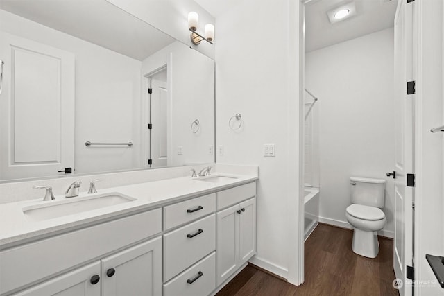 full bathroom with wood-type flooring, shower / bath combination, toilet, and vanity