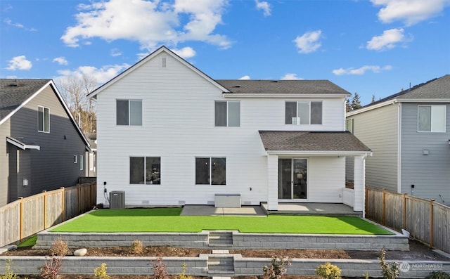 rear view of house featuring a patio area, a lawn, and central air condition unit