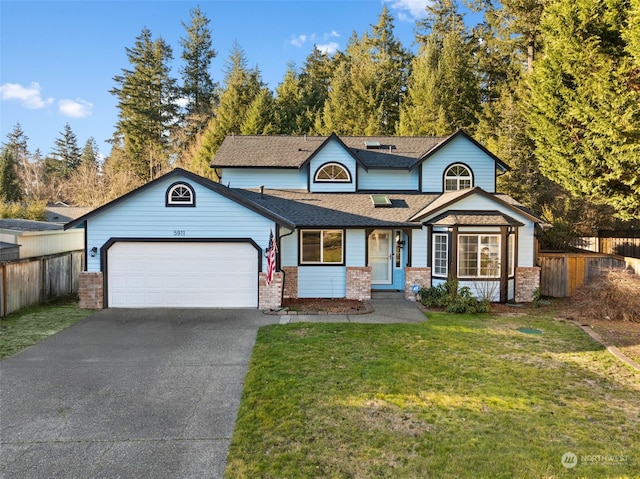 view of front of home featuring a front yard and a garage