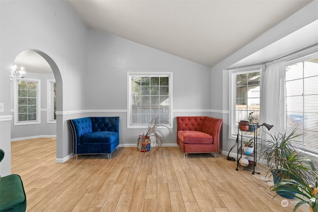 living area featuring light wood-type flooring and vaulted ceiling