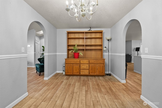 interior space featuring light hardwood / wood-style floors and a textured ceiling