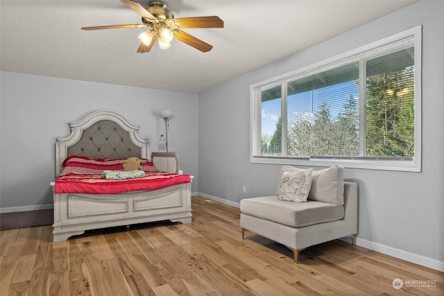 bedroom with light wood-type flooring and ceiling fan