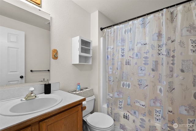 full bathroom with a textured ceiling, toilet, shower / bath combination with curtain, and vanity