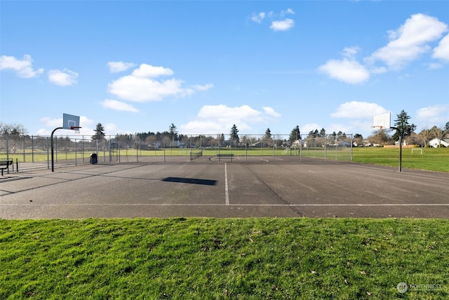 view of sport court featuring a lawn