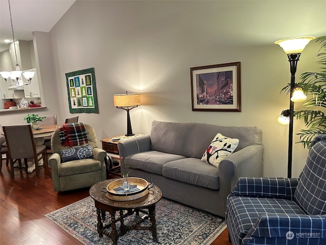 living room featuring an inviting chandelier and dark hardwood / wood-style floors