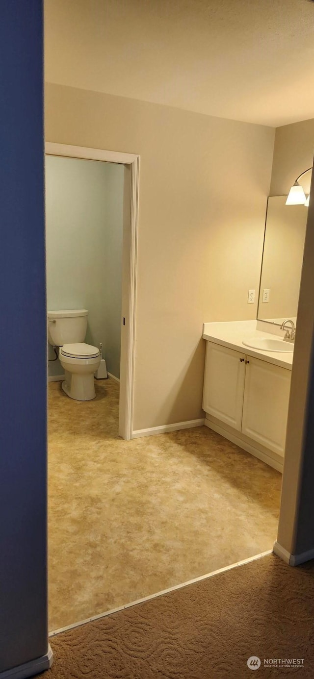 bathroom featuring toilet and vanity