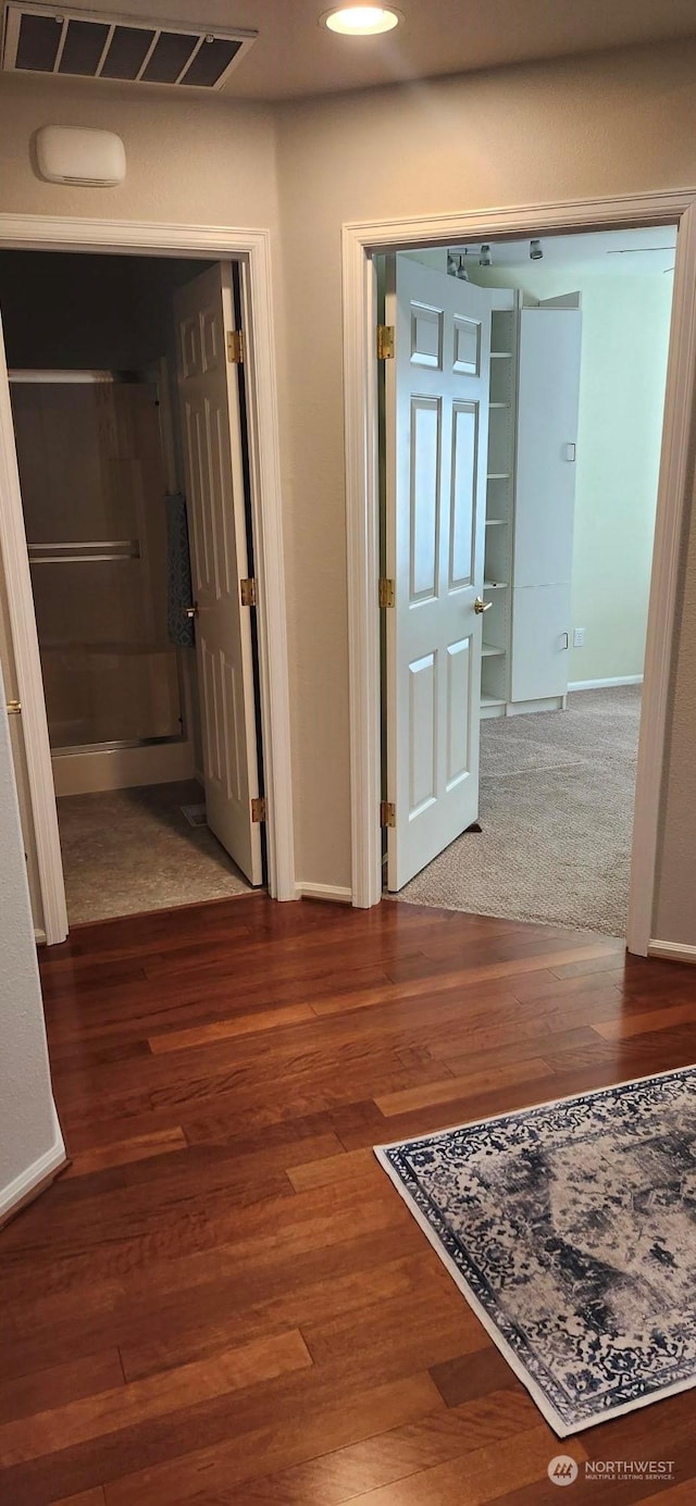 hallway with hardwood / wood-style flooring