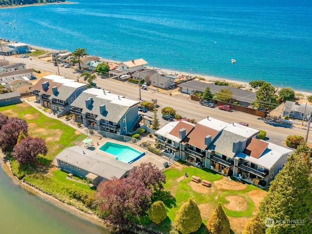 bird's eye view featuring a water view and a beach view