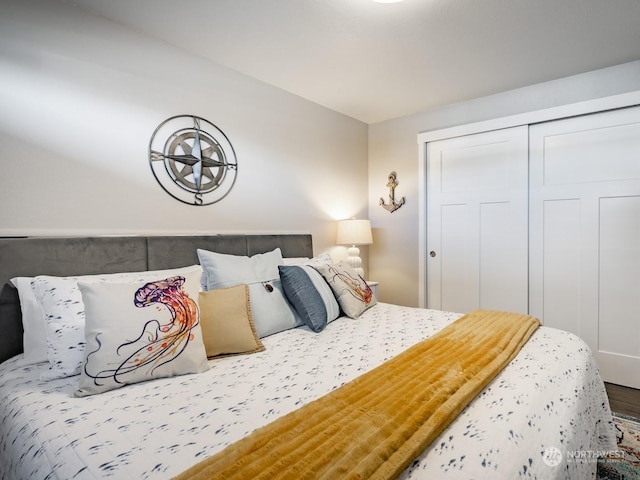 bedroom featuring hardwood / wood-style floors and a closet