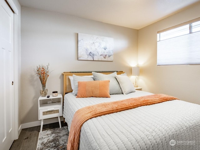 bedroom featuring dark hardwood / wood-style floors and a closet