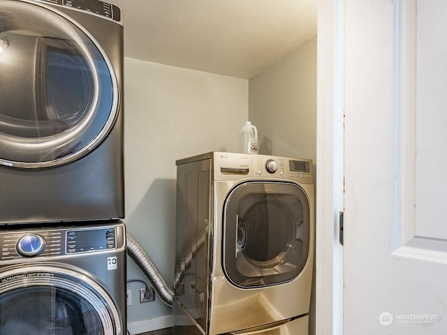 washroom featuring stacked washer / drying machine