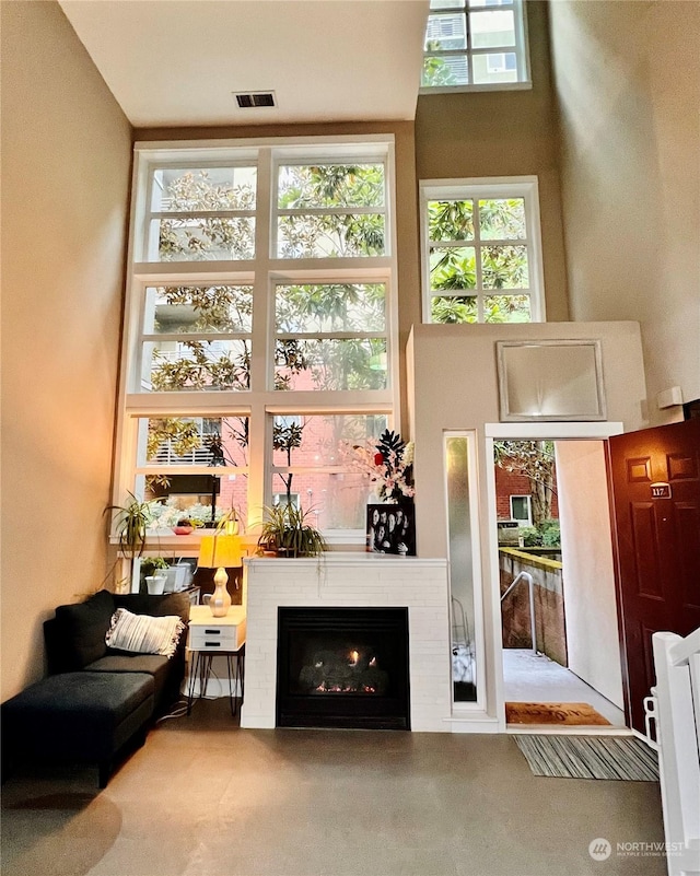 carpeted living room with a towering ceiling