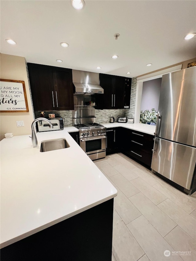 kitchen featuring wall chimney exhaust hood, sink, light tile patterned flooring, decorative backsplash, and stainless steel appliances