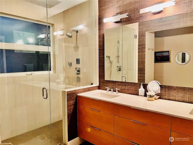 bathroom with vanity and a shower with door