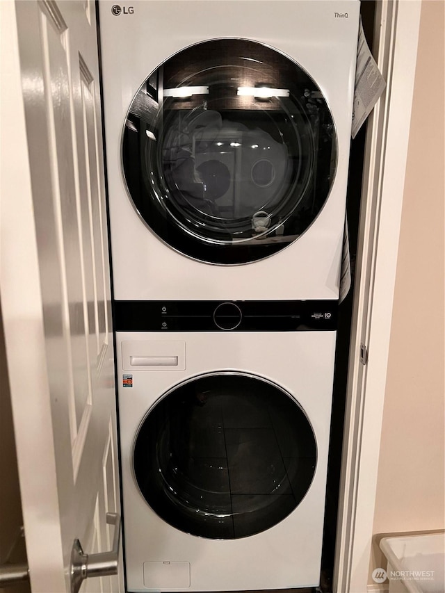 laundry area featuring stacked washer / drying machine