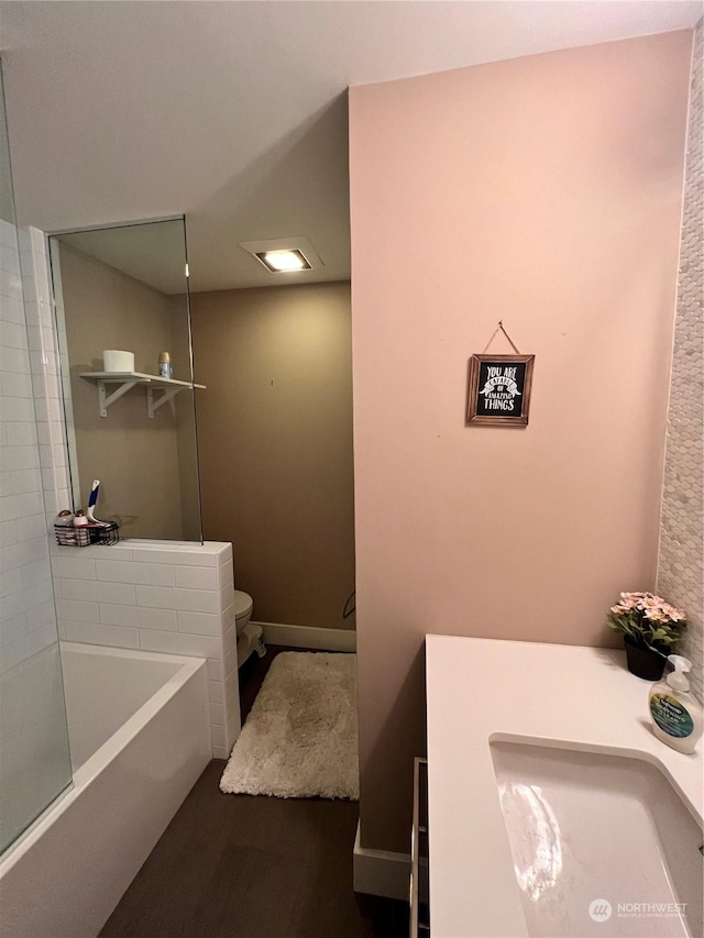 bathroom with sink, hardwood / wood-style floors, and toilet