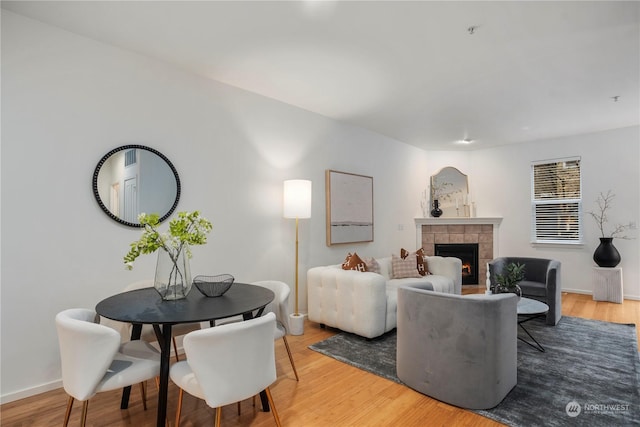 living room with wood-type flooring and a fireplace