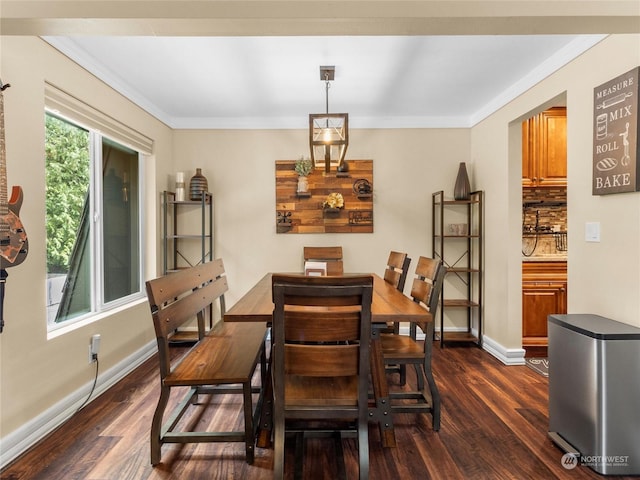 dining room with dark wood-type flooring and ornamental molding