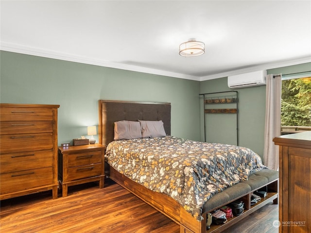 bedroom with a wall unit AC, ornamental molding, and wood-type flooring