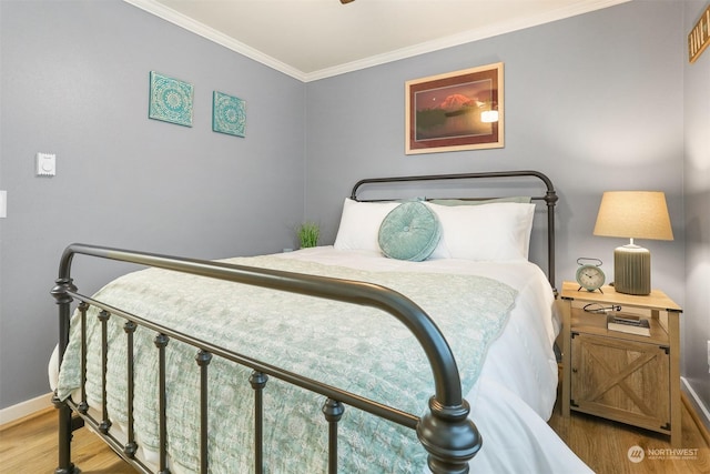 bedroom featuring crown molding and wood-type flooring