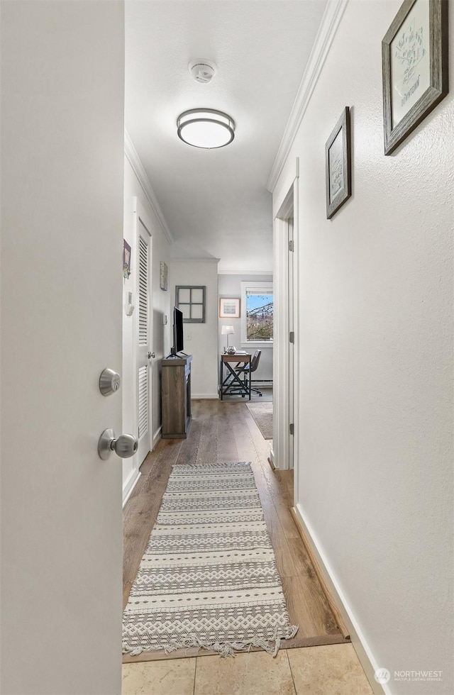 corridor featuring hardwood / wood-style flooring and ornamental molding