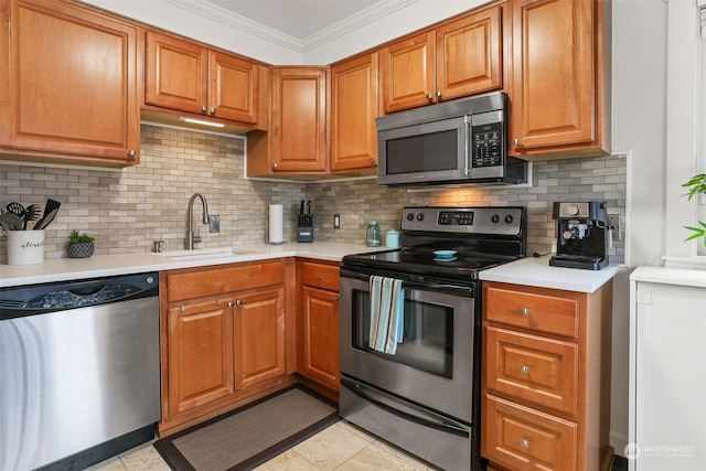 kitchen featuring sink, crown molding, tasteful backsplash, light tile patterned floors, and stainless steel appliances