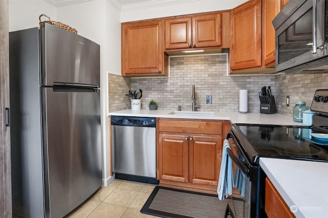 kitchen with sink, crown molding, light tile patterned floors, stainless steel appliances, and backsplash