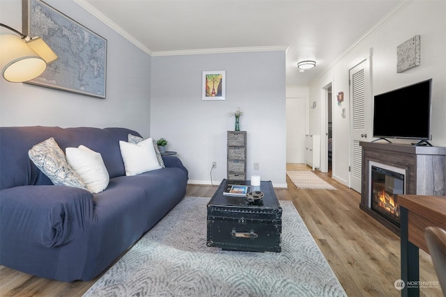 living room with hardwood / wood-style flooring and crown molding