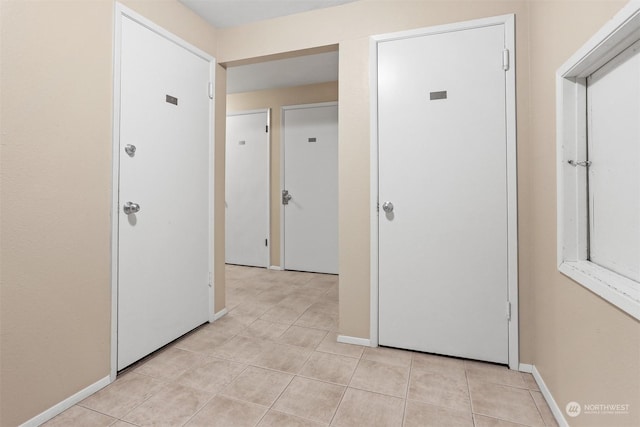 hallway with light tile patterned floors