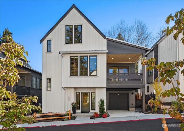 modern inspired farmhouse with a balcony and a garage