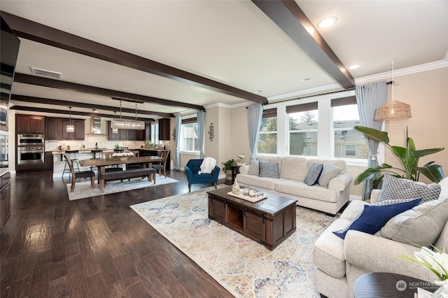 living area featuring beamed ceiling, visible vents, dark wood finished floors, crown molding, and baseboards