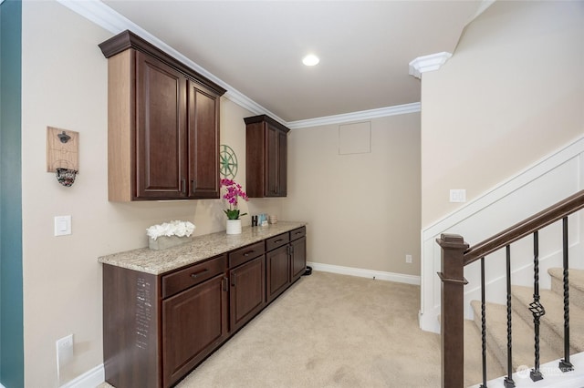 interior space featuring light colored carpet, crown molding, and baseboards