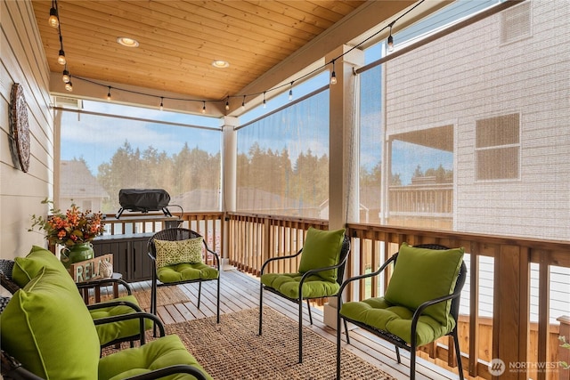 sunroom featuring plenty of natural light and wooden ceiling