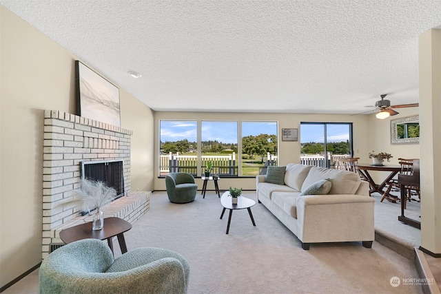 carpeted living room featuring a fireplace, a textured ceiling, and ceiling fan