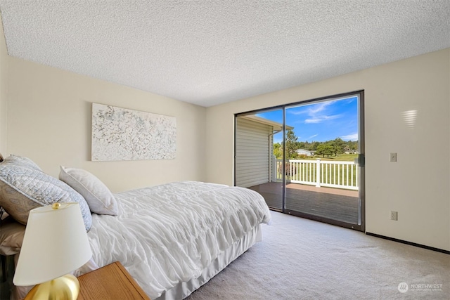 bedroom featuring light colored carpet, a textured ceiling, and access to outside