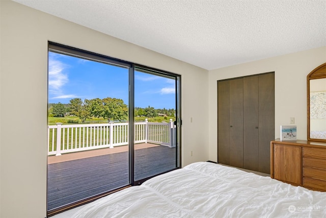 unfurnished bedroom featuring a textured ceiling, a closet, and access to outside