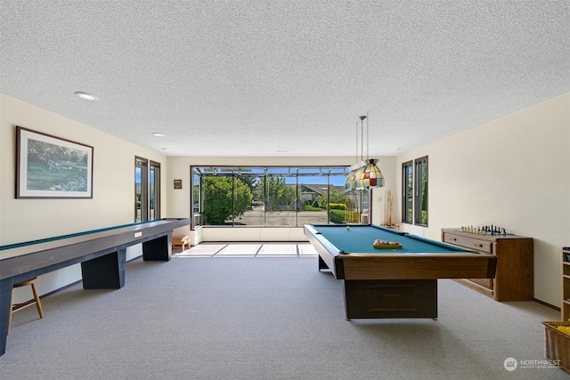 rec room with light colored carpet, a textured ceiling, and pool table