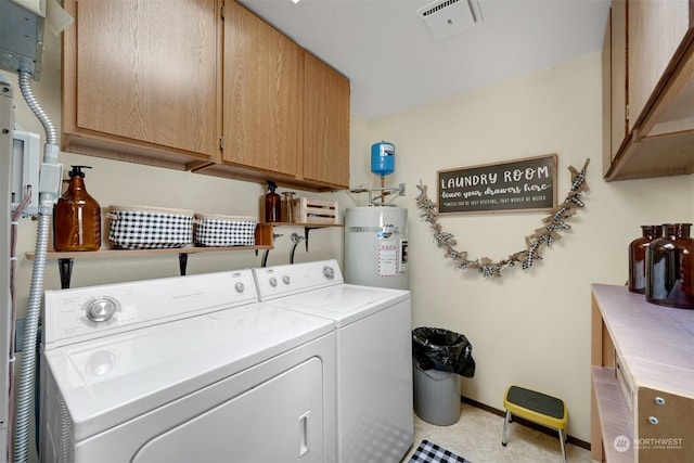 washroom with cabinets, secured water heater, and washing machine and clothes dryer