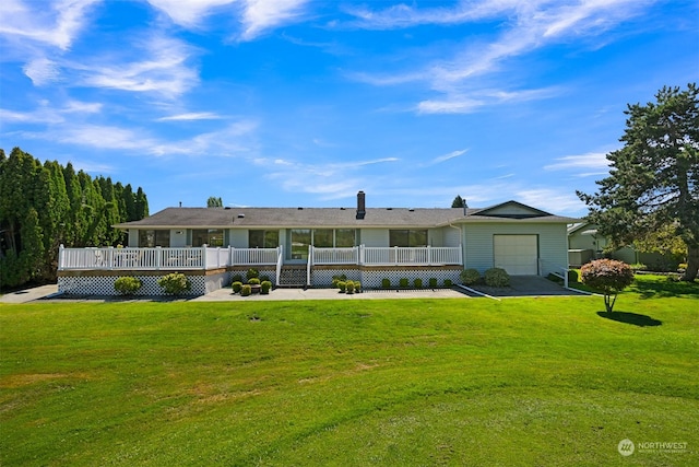 back of house with a garage, a wooden deck, and a lawn