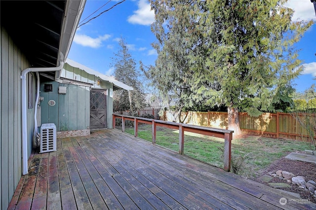 wooden terrace featuring ac unit