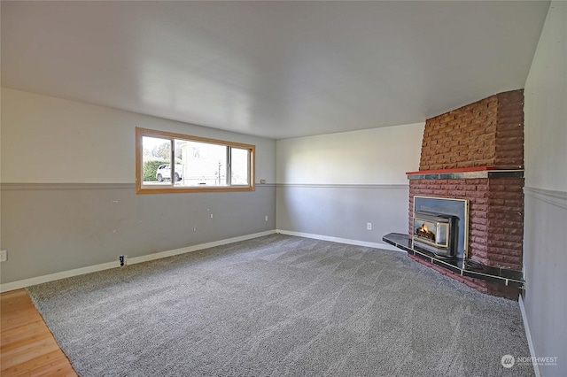 unfurnished living room with a wood stove