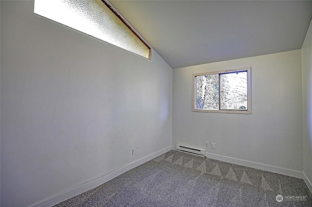 spare room featuring baseboard heating, lofted ceiling, and carpet flooring