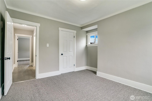 unfurnished bedroom featuring carpet floors and baseboards