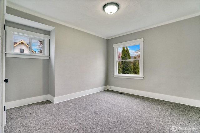 unfurnished room with carpet flooring, baseboards, and ornamental molding